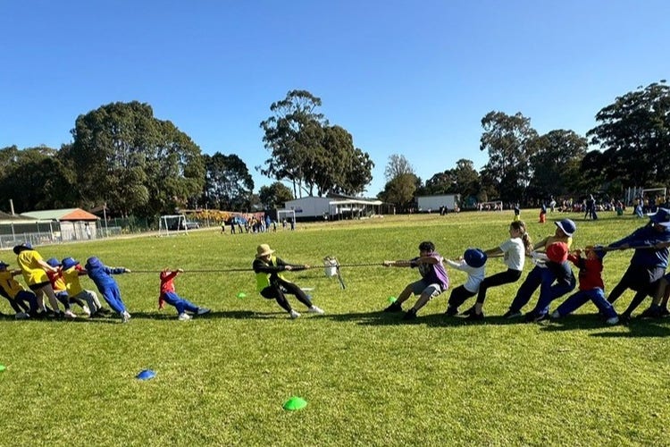 students playing tug-of-war on the school oval