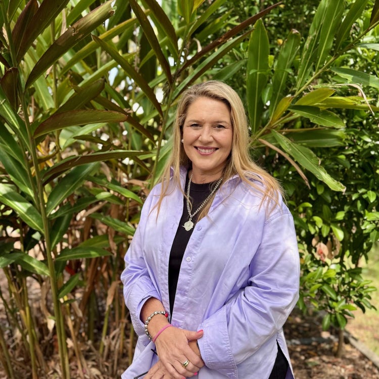 picture of the school principal standing in front of a tree