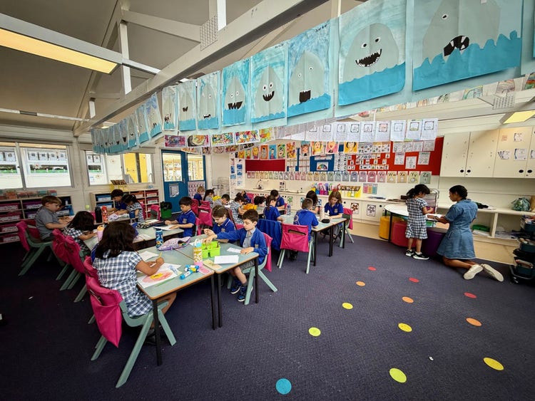bright classroom with students working at the desks