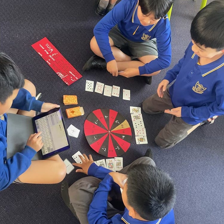 students playing their chance board games they designed