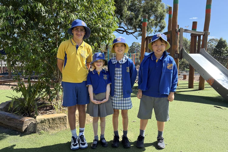 One student in their sports uniform and three students in their summer uniform