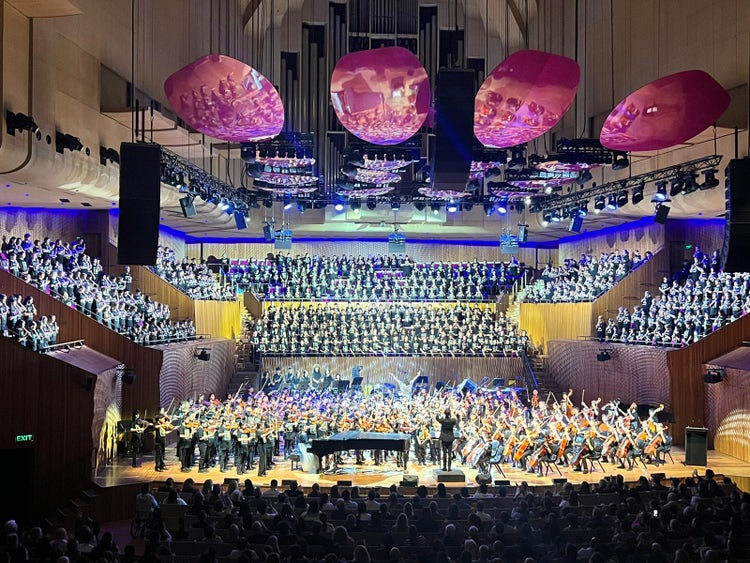 choir and string ensemble performing on stage
